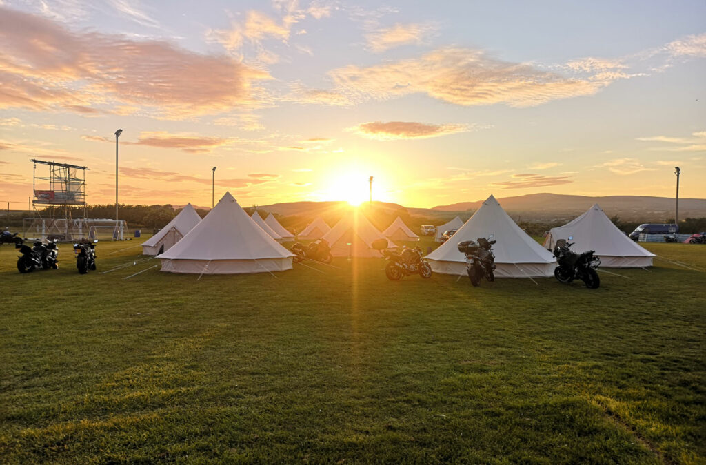 The sun setting over Isle of Man TT 2024 accommodation in luxury bell tents