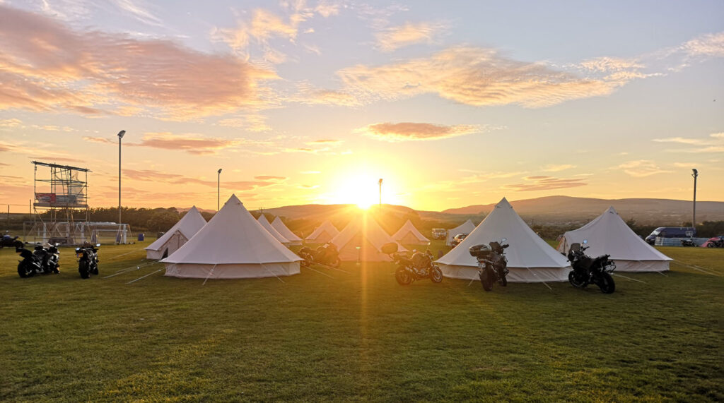 The sun setting over Isle of Man TT 2024 accommodation in luxury bell tents