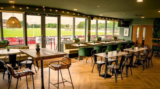 Bar and seating area at Fylde Rugby Club overlooking the field.